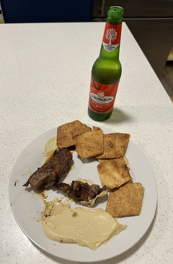 A plate of food and a beer bottle