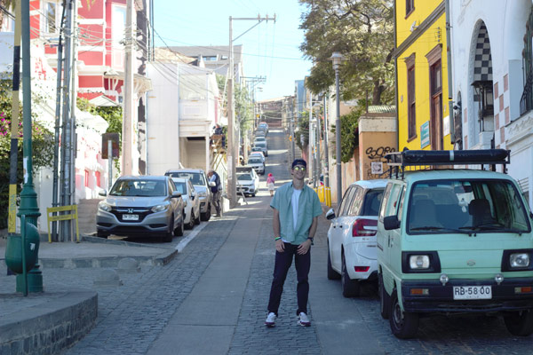 A study abroad student posing on a street and smiling at the camera