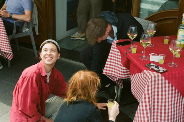 Friends sitting and smiling around a table