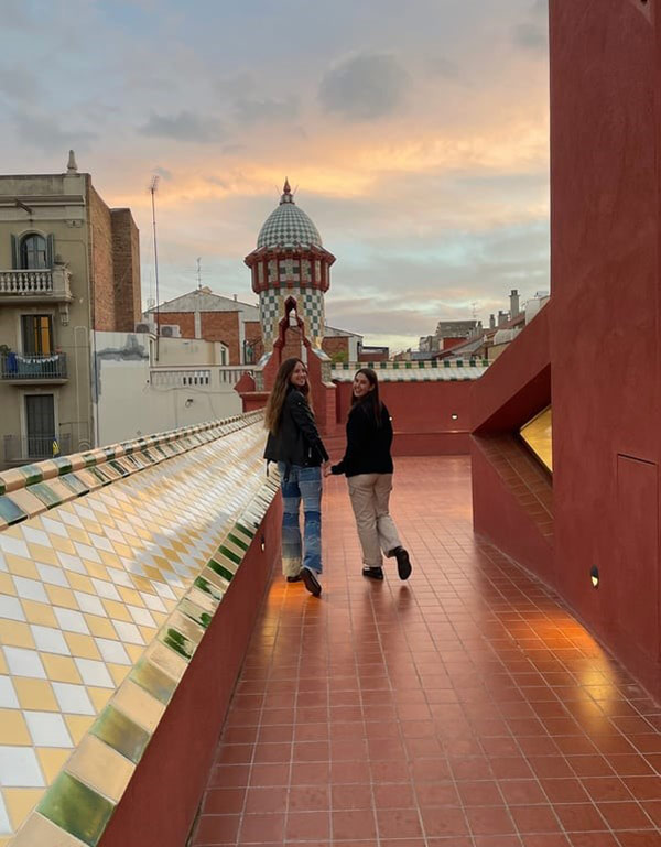 Two women standing on a roof
