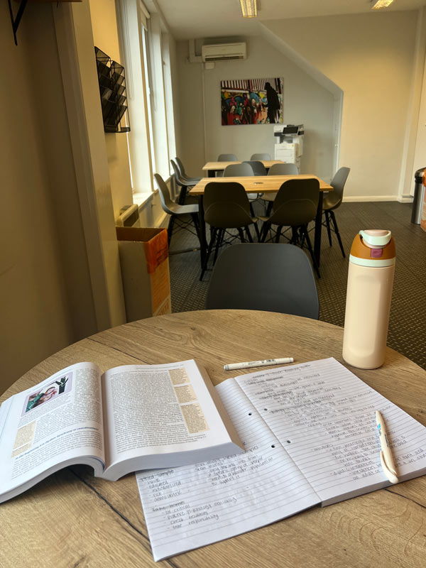 a table with a book and pen on it at a study abroad center