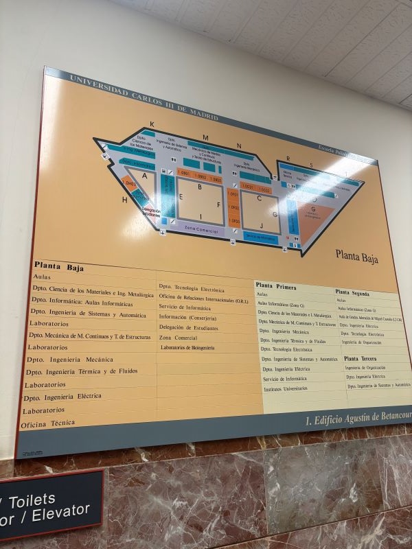 A large map on a wall detailing sections of a university campus building
