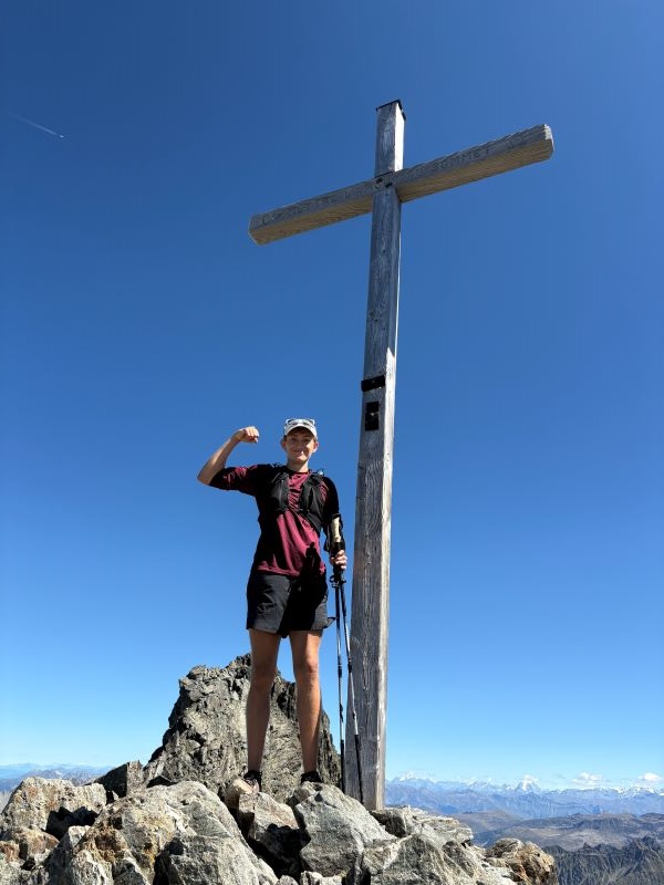 Study abroad student posing at top of mountain