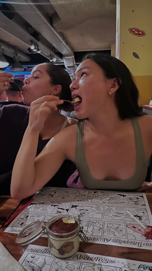 Two study abroad students eating from a spoon