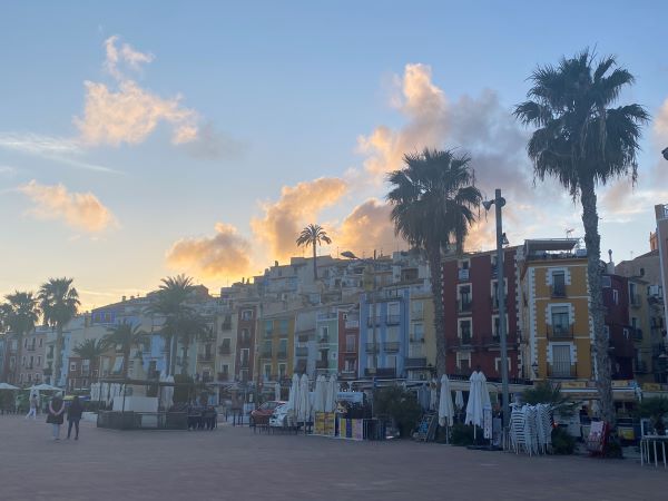 Colored buildings with vendors in front