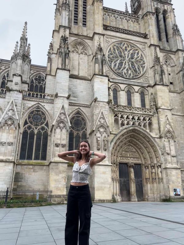 Study abroad student posing for photo in front of the French Cathedral