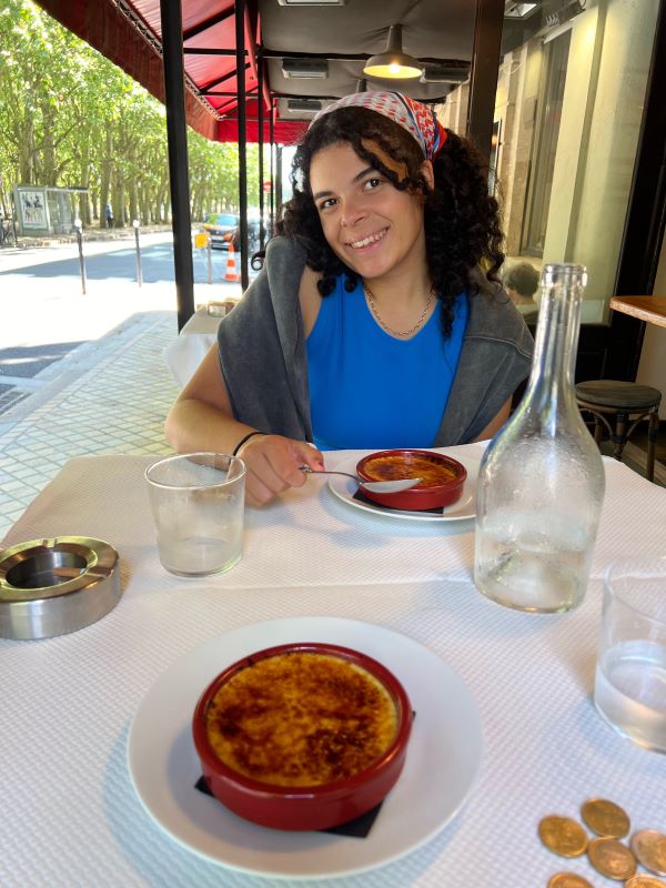 Study abroad student eating creme brulee
