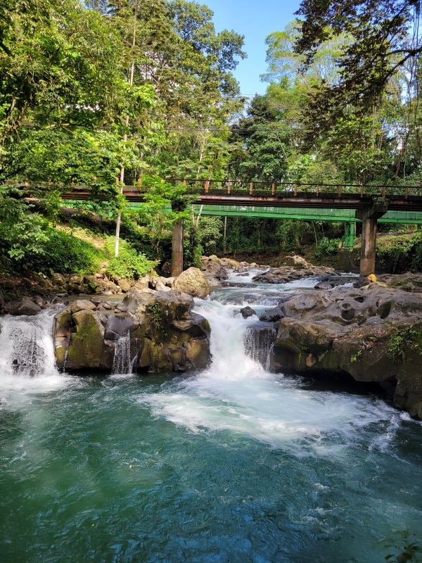 River and waterfall under bridge