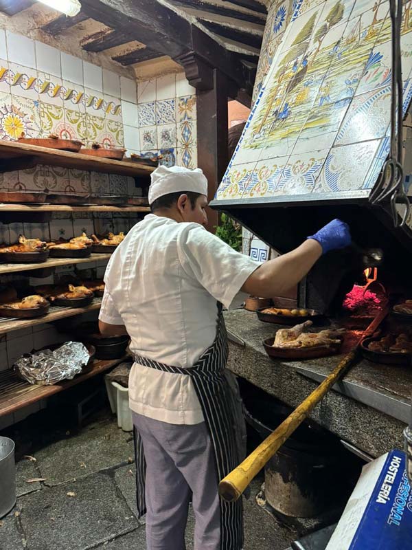 A person in a chef's uniform cooking food