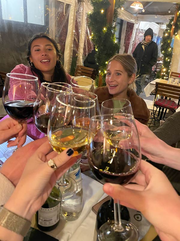 A group of study abroad students holding wine glasses