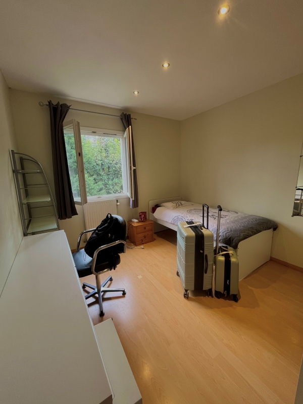 French homestay room with luggage and bedding