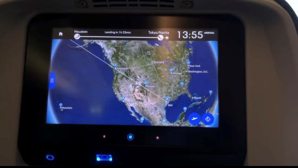 A screen on the back of an airplane seat featuring a geographic view of the North American continent