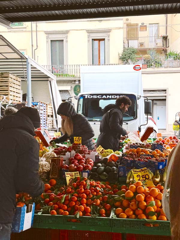 People at a market with fruits and vegetables