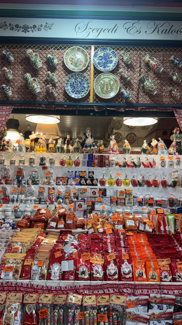 A market stand full of multiple rows of products, mostly colored red and orange and featuring paprika imagery