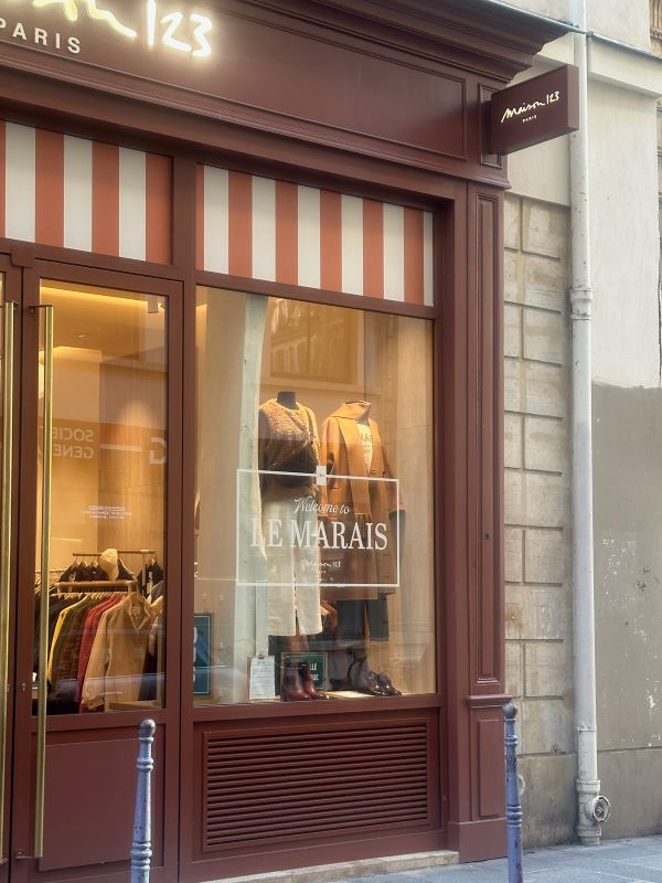 A storefront featuring a window sign that reads