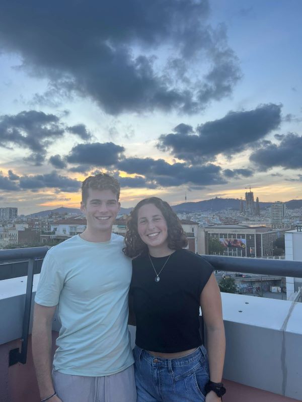 Two study abroad students posing for photo on rooftop
