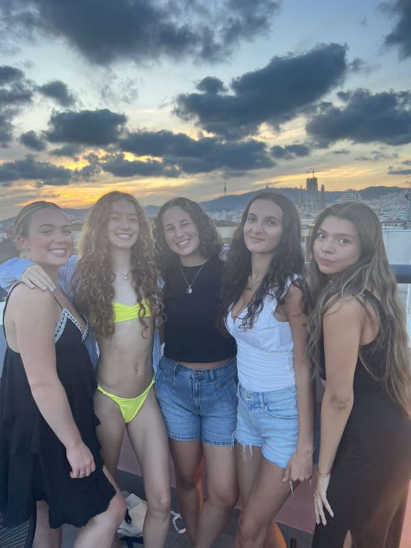 Five study abroad students posing for photo on rooftop