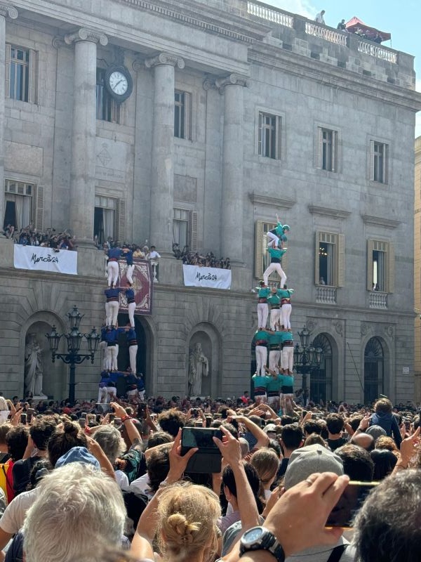 Photo of crowd observing castellers, human towers