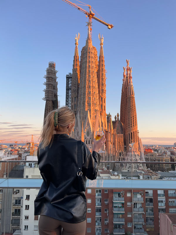 A person standing on a balcony overlooking Sagrada Família