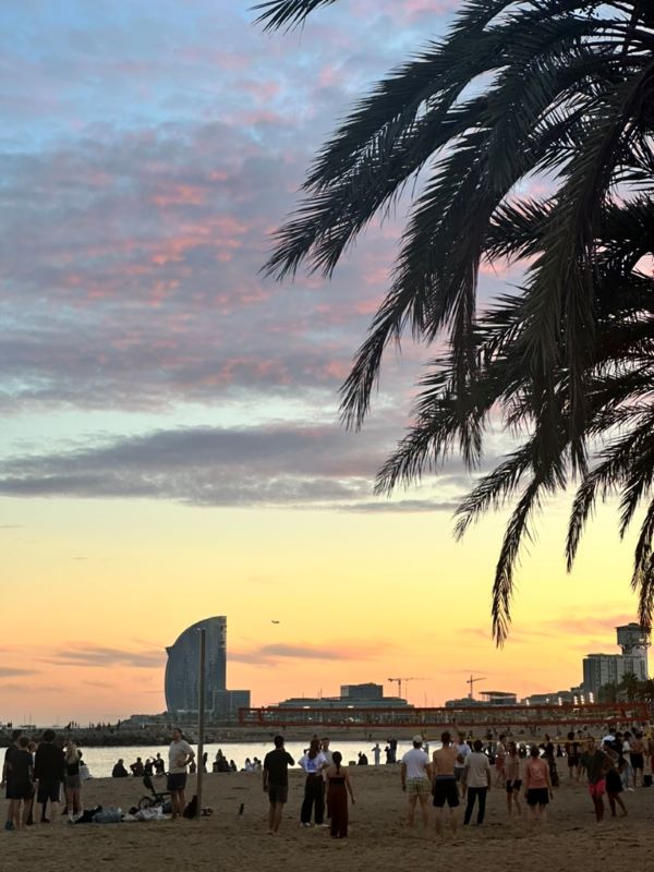 Crowded beach during sunset