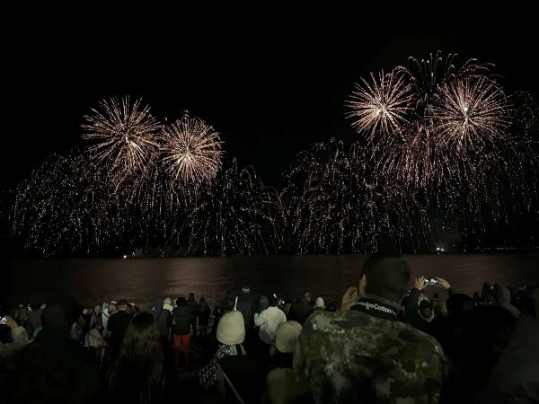 Photo of fireworks going off over the ocean