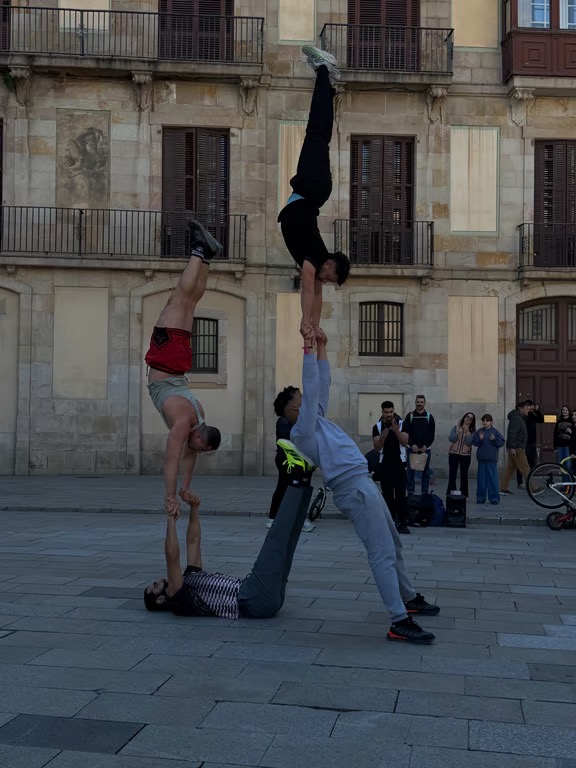 Four street performers in an gymnastic pose together