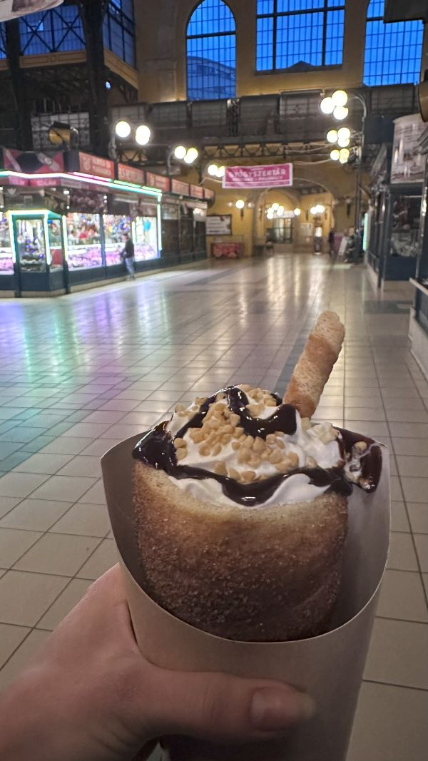 Study abroad student holding a chimney cake