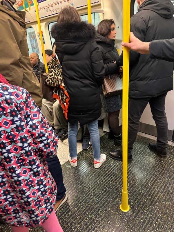 A group of people standing in a public transportation carriage