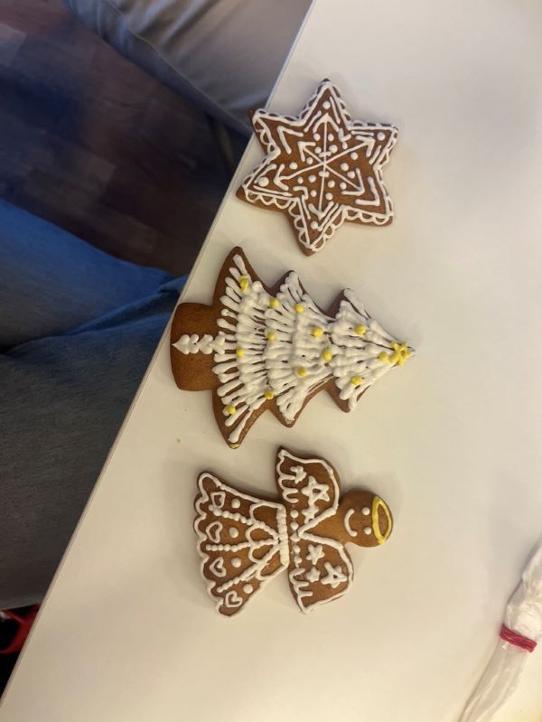 Three gingerbread cookies with decorated icing