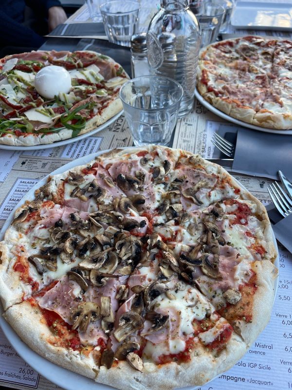 Three pizzas with a variety of toppings