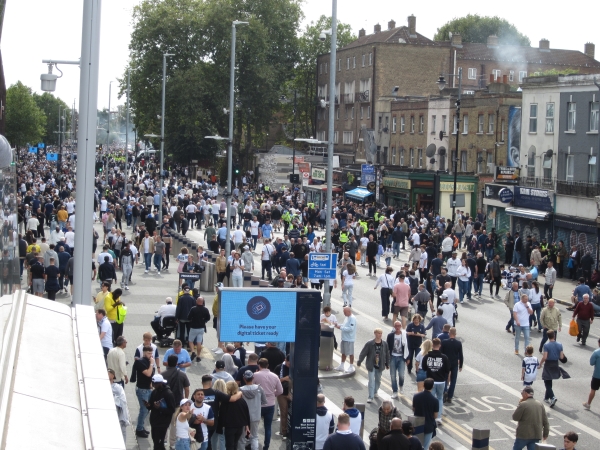 Street outside stadium for game-day featuring large crowd of fans