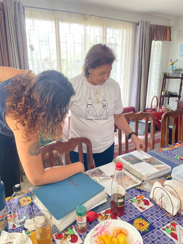 Host mom showing study abroad student a scrapbook