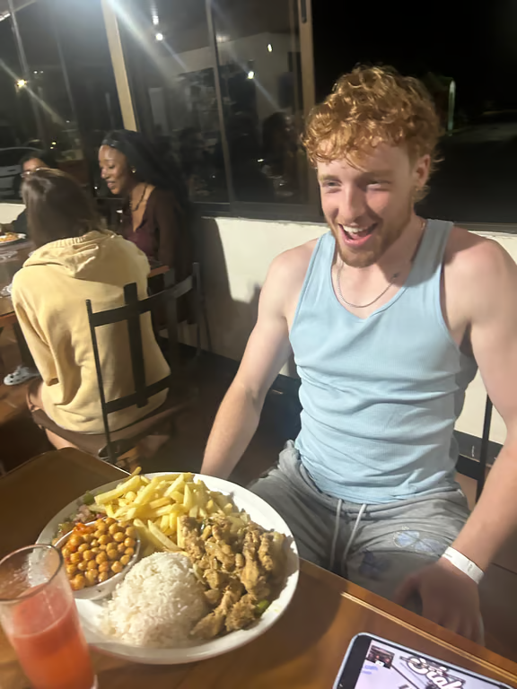 Study abroad student with large plate of food