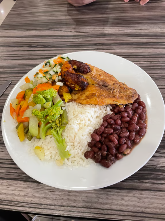 Plated casado consisting of rice, beans, plantains, and veggies