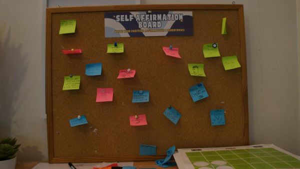 A corkboard on a wall with the words