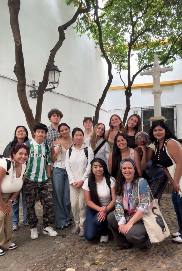 A group of study abroad students standing together outdoors and smiling at the camera