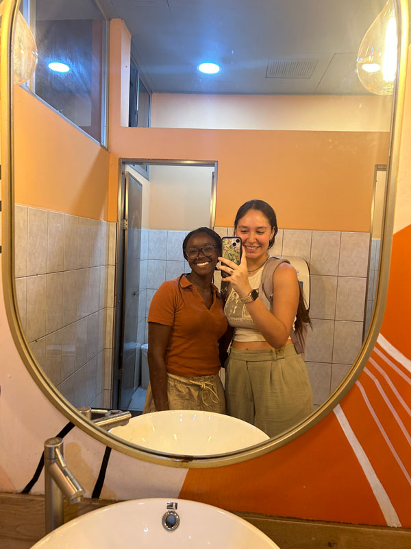 Two study abroad students taking a selfie in a mirror