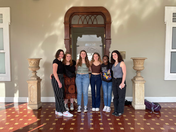 A group of study abroad students standing in front of a doorway