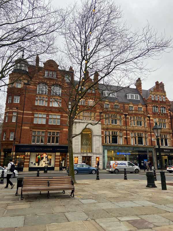 A tall ornate brick building on a city street