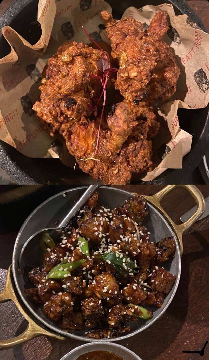 A plate of lollipop chicken and a plate of sesame vegetables