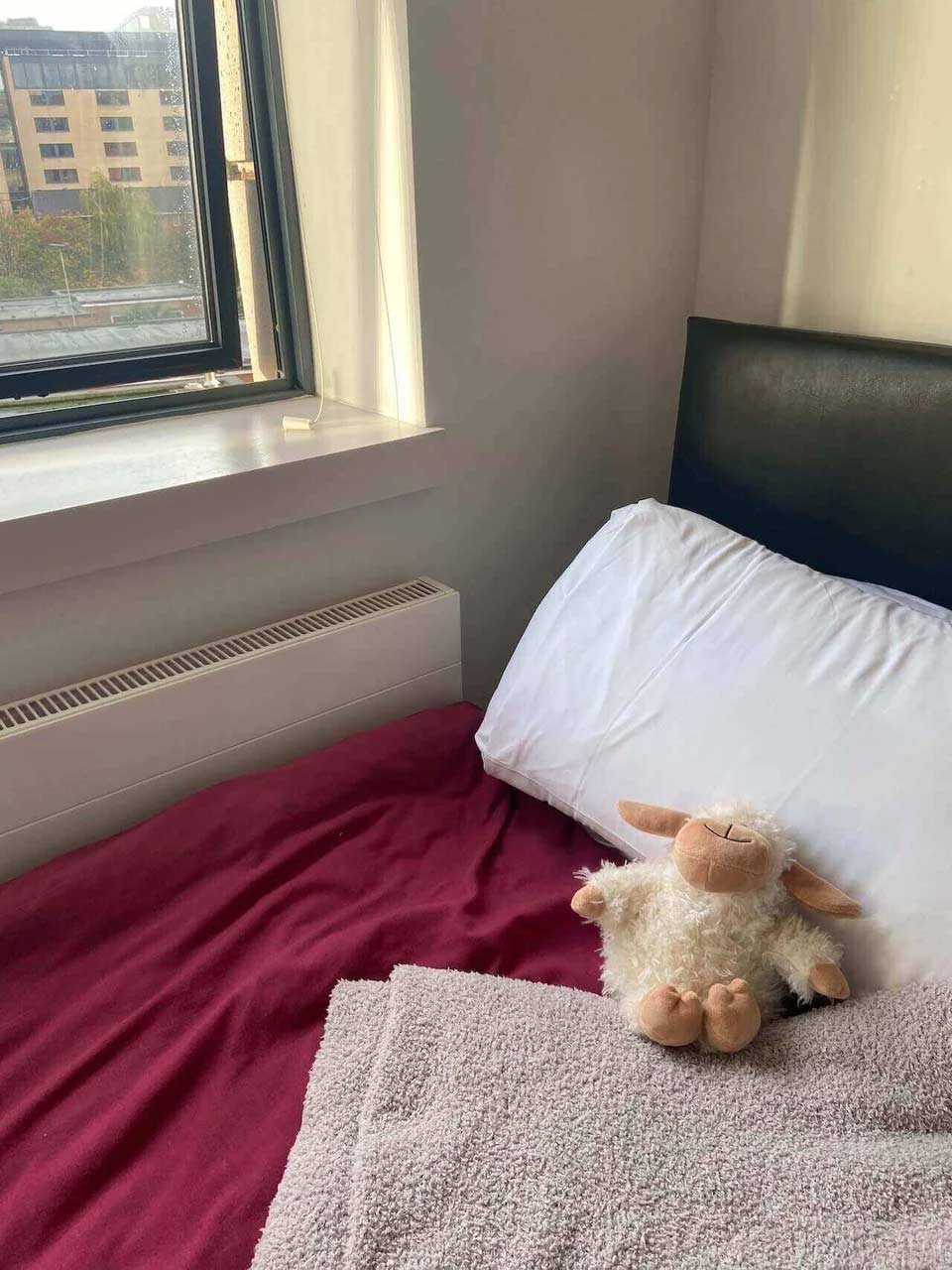 A stuffed toy on a made bed