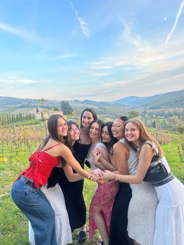 Study abroad students posing for photo at winery