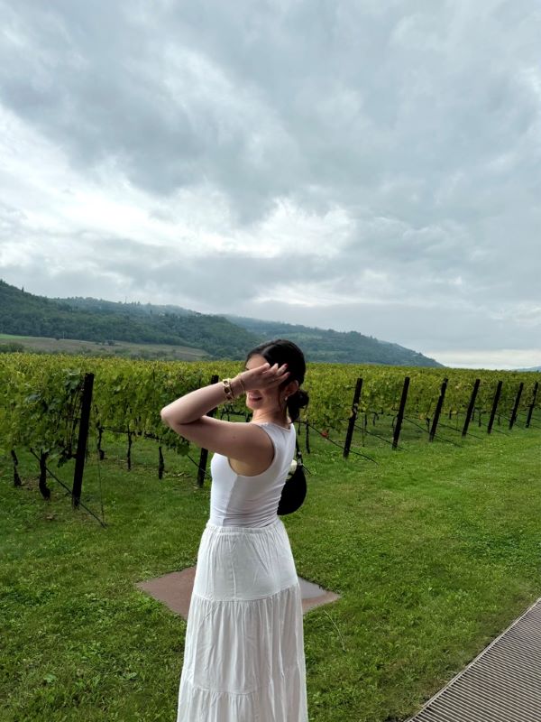Study abroad student posing for photo at winery