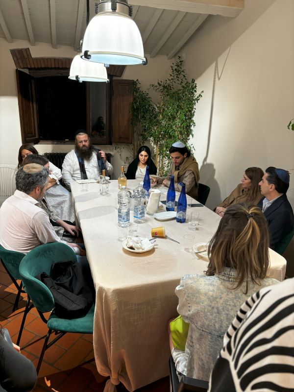 Dinner table surrounded by Jewish community members
