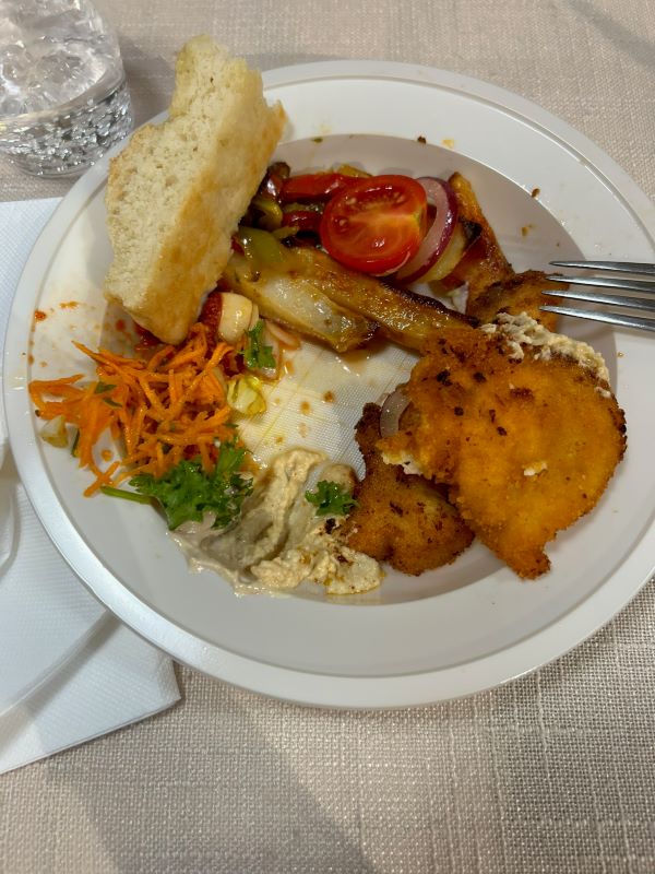 Plated dish with chicken, veggies, and bread