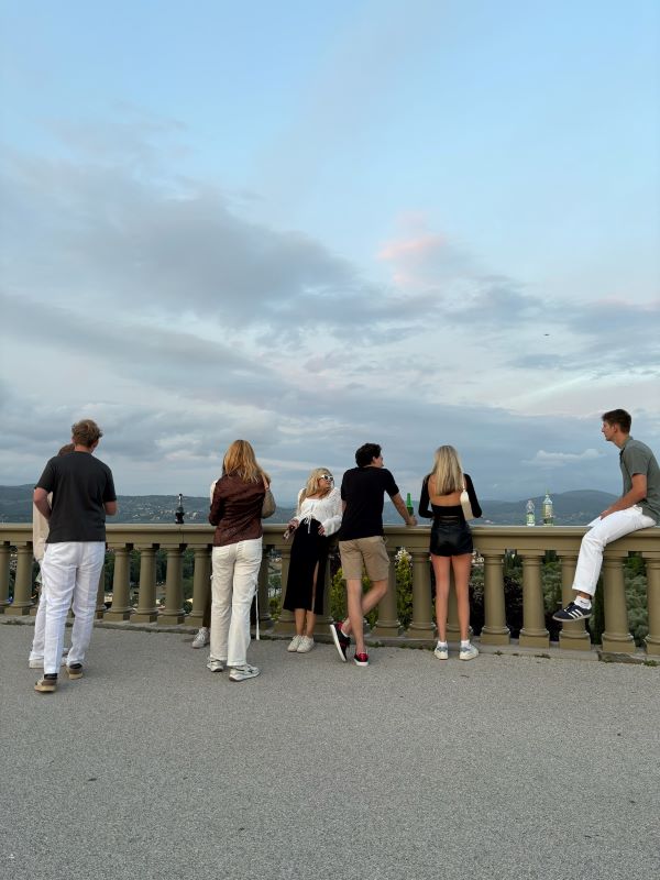 Group of study abroad students hanging near balcony
