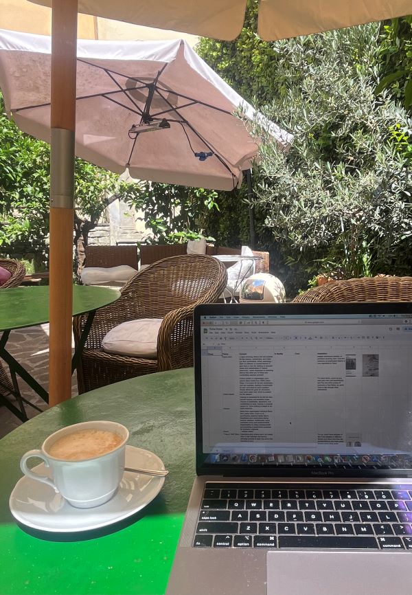 Latte with computer open at cafe