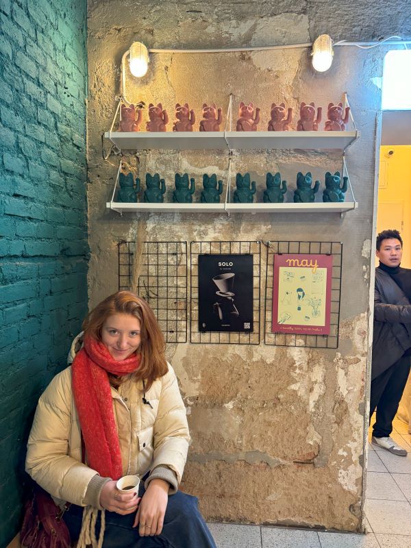 Study abroad student posing for photo in local cafe