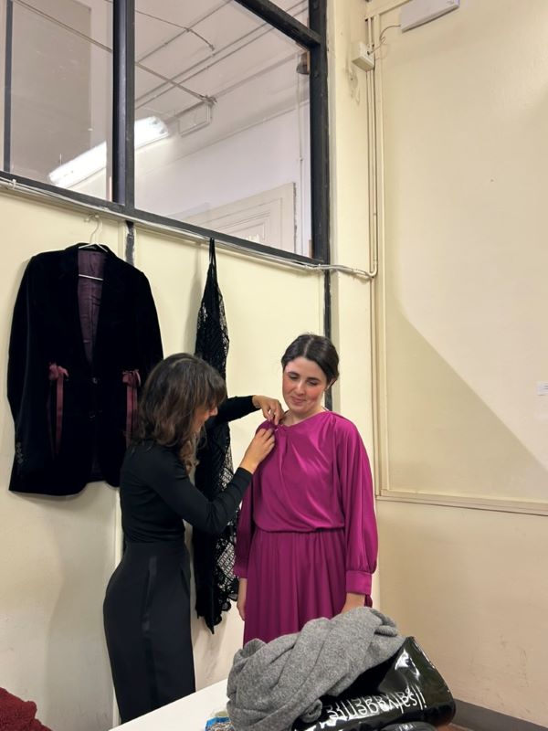 Fashion designer making alterations on pink dress