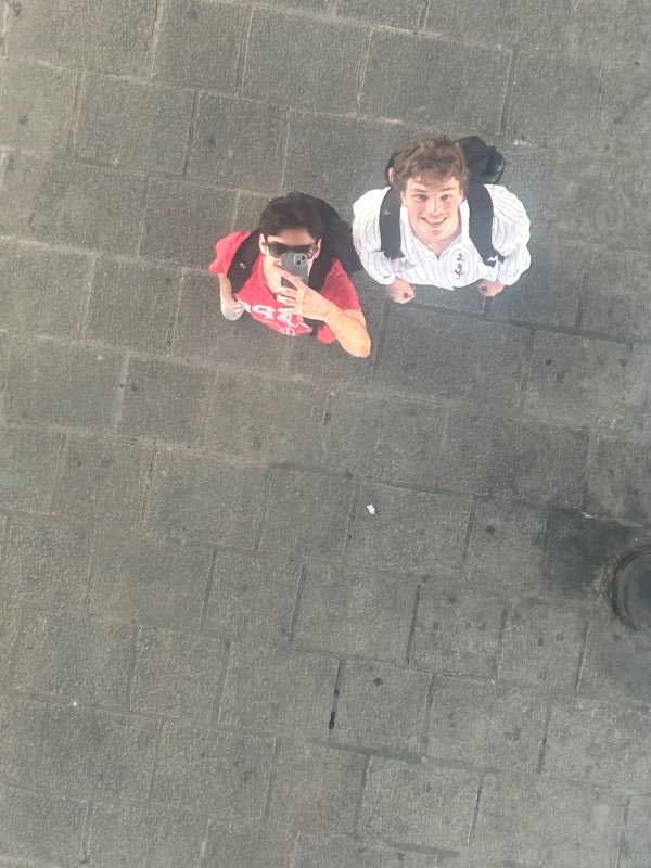 Two study abroad students as seen from above taking a selfie looking up into a mirror